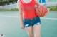 A woman holding a basketball on a basketball court.