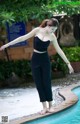 A woman standing on the edge of a swimming pool.